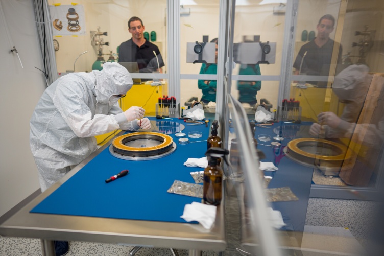 Scientist in a "bunny suit" works on a NASA project in a clean room