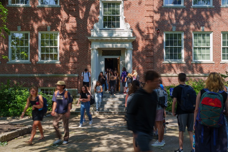 Students moving in and out of a campus building