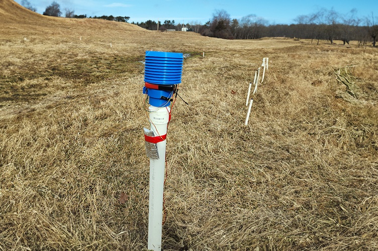 A photo of a sensor standing in a pasture field