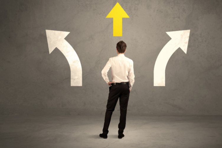 Stock photo of man considering multiple potential paths Stock photo of man considering multiple potential paths