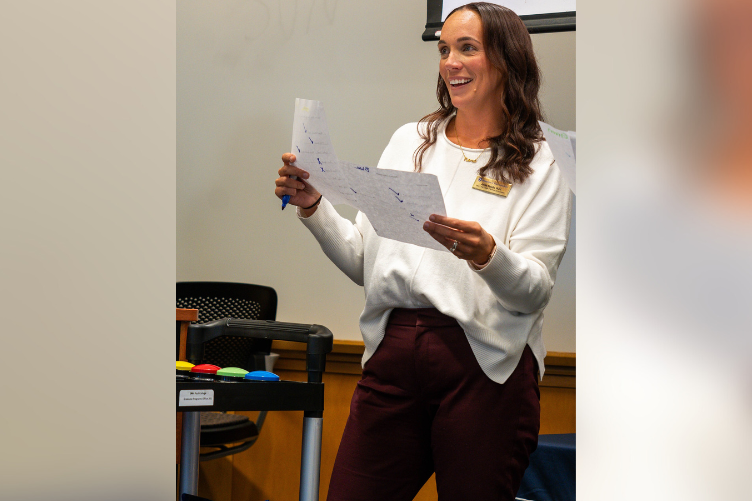 Annie Nevells, director of graduate enrollment and advising, welcomes grad students to a recent mixer event at Paul College. Annie Nevells, director of graduate enrollment and advising, welcomes grad students to a recent mixer event at Paul College..