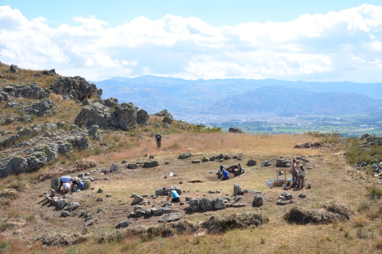 From a distance we see a circle of stones on a mountainside.