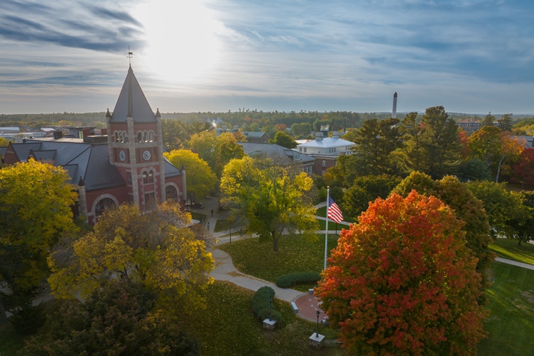 Aerial view of Thompson Hall during fall, surrounded by colorful trees