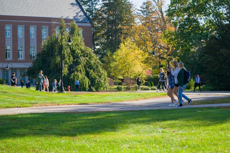 Students walking on campus path in spring