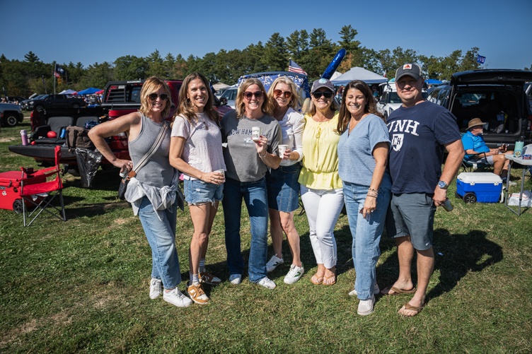 A group of UNH alumni stand together to pose for a photo