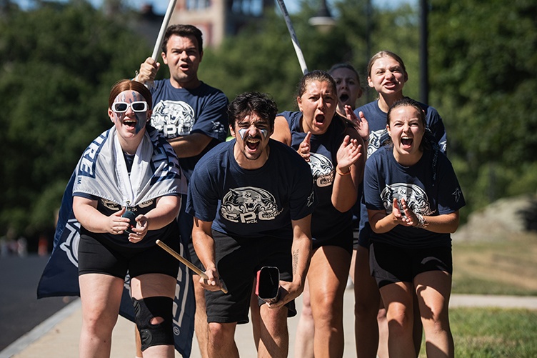 UNH Cat Pack Captains cheer enthusiastically as new students arrive