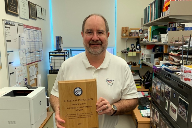 Professor Russ Congalton holding up his AmericaView Lifetime Achievement Award