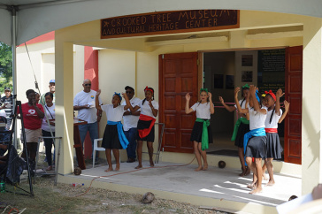children dancing in front of museum