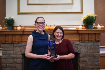 Alley Leach and Jenn Andrews from UNH Sustainability Institute hold their UNH Innovator of the Year trophy