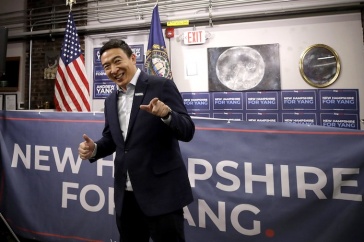 Andrew Yang in front of NH sign