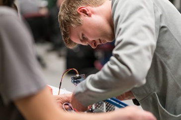 Engineering technology student studies control systems design in the lab at UNH Manchester