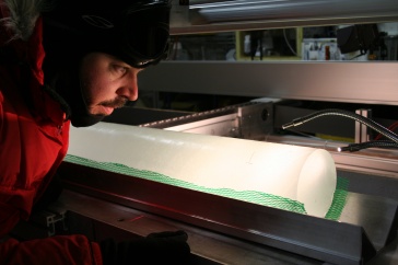 Joe Souney inspects an ice core from Antarctica.