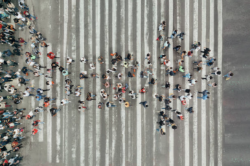 Image of people crossing the street in the form of an arrow