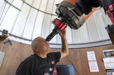 John Gianforte looking through telescope