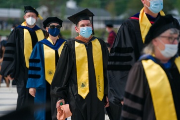 students walking in for commencement