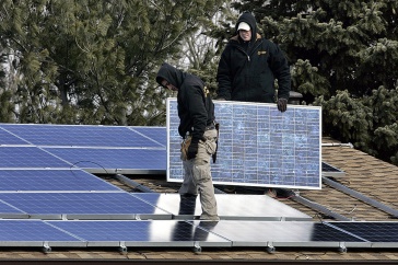 Image of man installing solar panels
