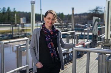 Paula Mouser stands on catwalk at Durham's wastewater treatment facility