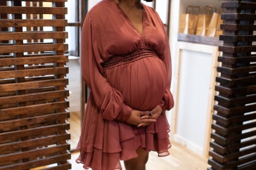 A photo of a pregnant mother standing in a doorway