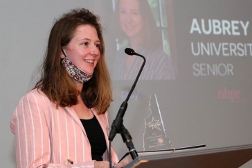 Aubrey Porter at podium at Stay Work Play awards ceremony