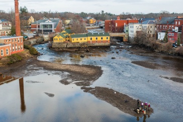 Aerial view of river with researchers working on sandbar