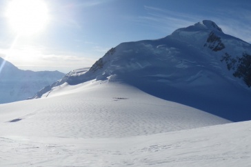 Remote Alaskan mountain with snow in foreground