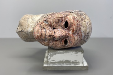 Plaster sculpture of a head lying on its side