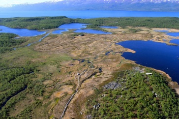 Aerial image of Abisko, Sweden, with lakes and green land near mountains.