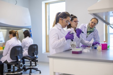 Dr. Kristen Johnson, right, working in the lab with students