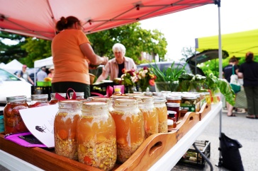 A photo of a vendor at the Exeter Farmers Market selling her items to a customer. New UNH research highlights New England consumers’ perspectives of farmers markets with the goal of identifying new strategies for making these and other alternative food markets more viable for farmers and food producers.