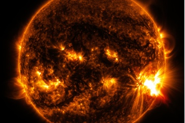 An image of the sun with orange flares on its surface.