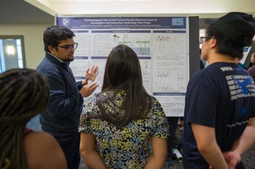 Image of student presenting poster at GRC. 