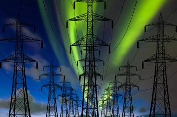An aurora visible over power lines