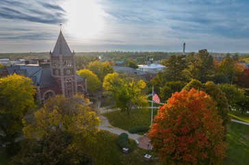 Aerial view of Thompson Hall during fall, surrounded by colorful trees