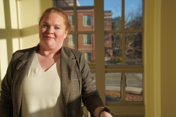 Katie Godshall poses in front of a window at UNH