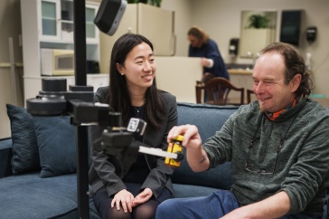 Jing Wang working with a robot.