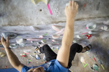 Rock climber shot from above at an indoor rock wall