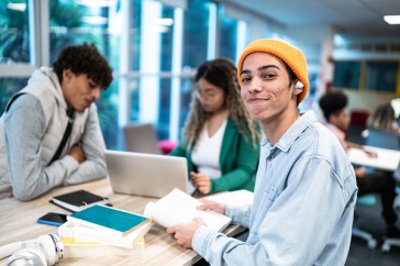 Stock photo of three students working at a table