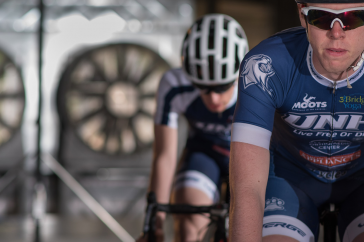 UNH undergraduate researchers on bikes in the wind tunnel