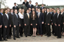 students from the atkins investment group in front of cat sculpture