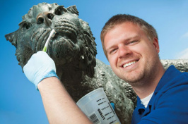 jameson coop cleaning the wildcat sculpture