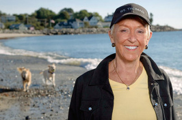 jo lamprey on the beach with her two dogs