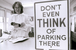 parking office with sign "don't even THINK of parking there"
