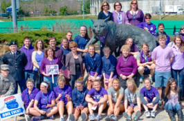 cooperative extention volunteers in front of cat sculpture