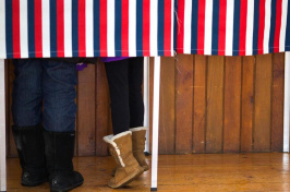 People stand in a booth while voting in the New Hampshire primary earlier this year (Photo by Keith Bedford, Globe Staff)