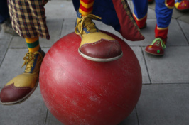 clown feet and a large red ball (Photo: Peter Nicholls / Reuters)