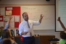 UNH alumnus Tate Aldrich teaches an English class at Laconia High School