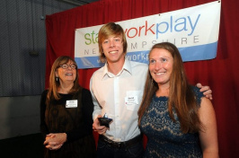 David Hutchings of Windham was presented with the 'Shire Story of the Year Video while flanked by Besty Gardella, left, of New Hampshire Public Radio, and Kate Luczko, president and CEO of Stay Work Play, at the Rising Stars awards sponsored by Stay Work Play New Hampshire hosted at Fieldhouse Sports in Bow on Monday. (Mark Bolton/Union Leader)