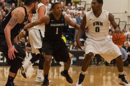UNH men's basketball player driving to the hoop