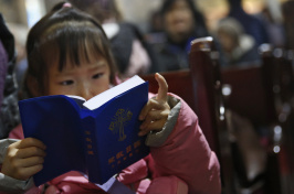 a chinese girl reading the Bible (EPA/How Hwee Young)