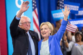 Democratic presidential candidate Hillary Clinton and Sen. Bernie Sanders (Vt.) wave after speaking at a rally in Portsmouth, N.H., in July. (Justin Saglio/Agence France-Presse via Getty Images)